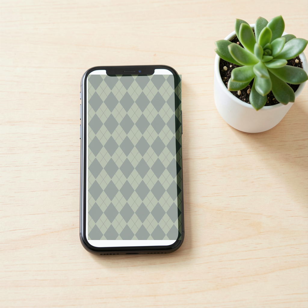 The Forest & Oatmeal argyle pattern shown at realistic scale in a desk scene